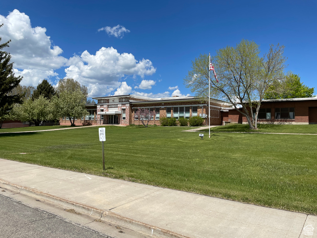 View of front facade with a front yard and brick siding