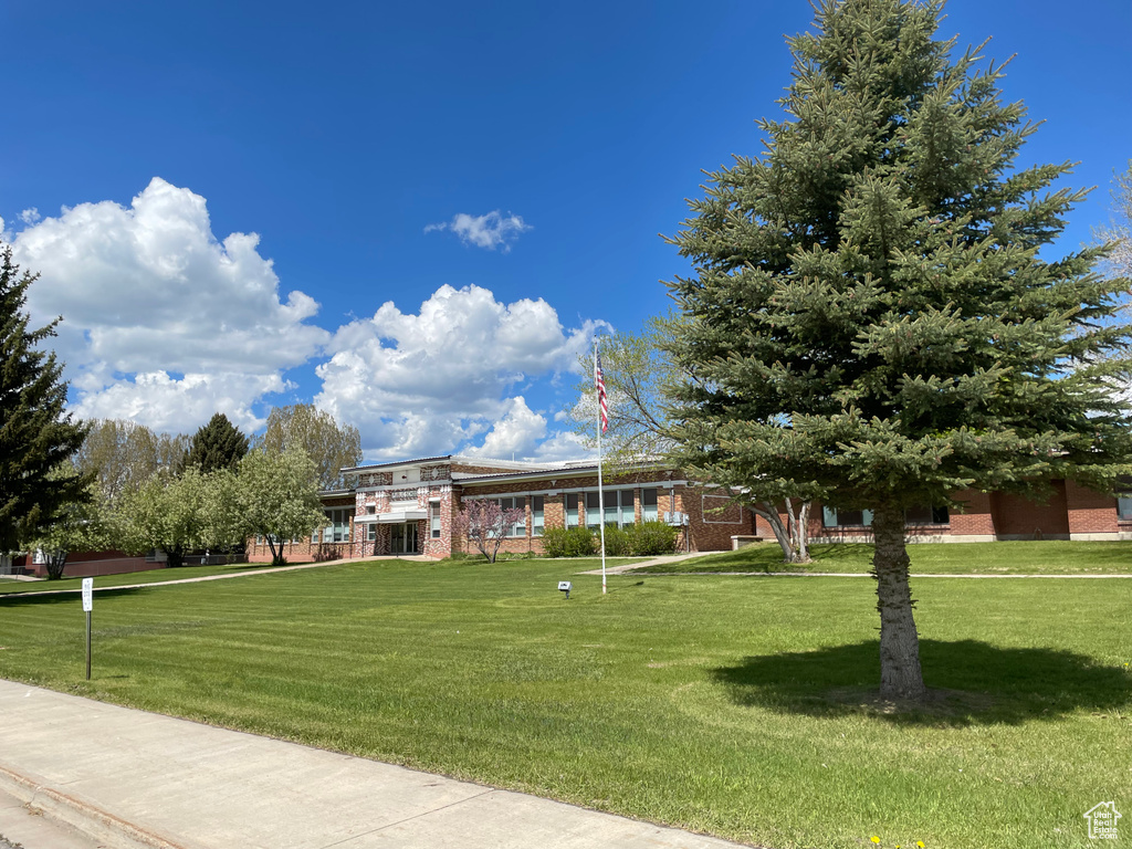 View of front facade featuring a front lawn and brick siding