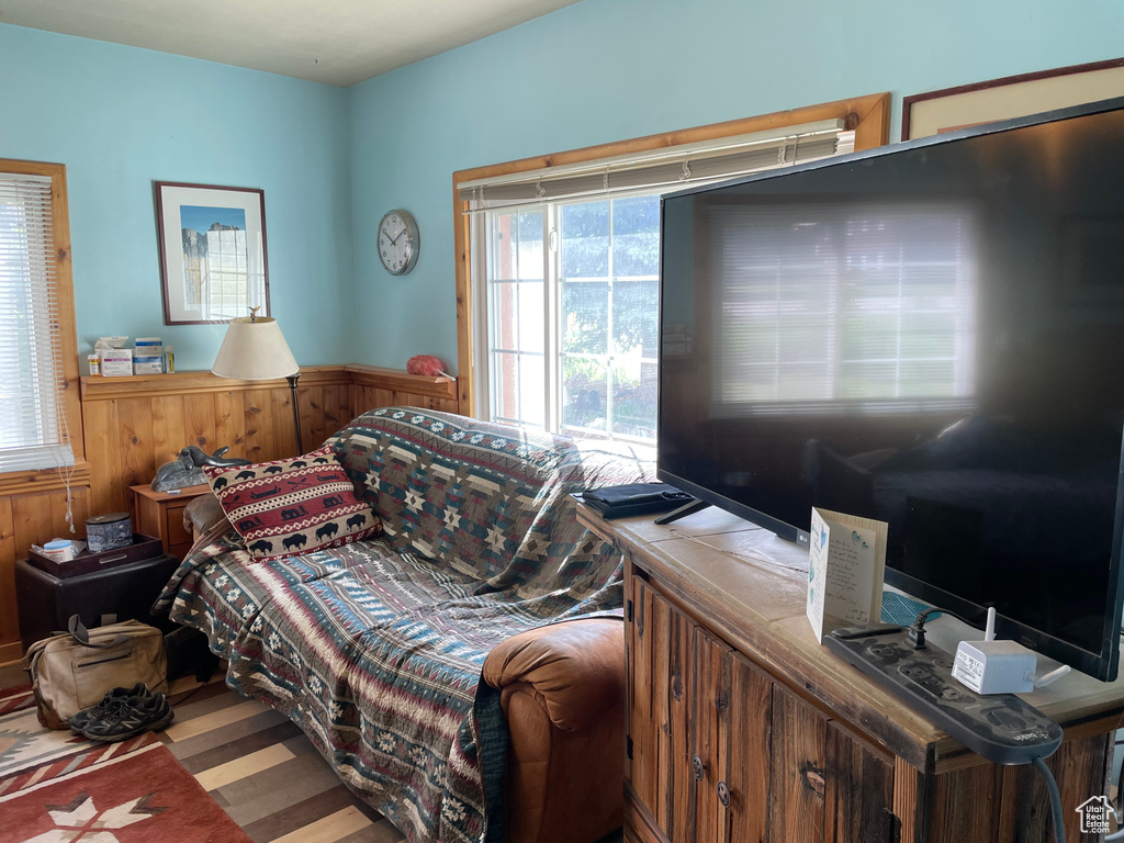 Bedroom with wood finished floors and wainscoting
