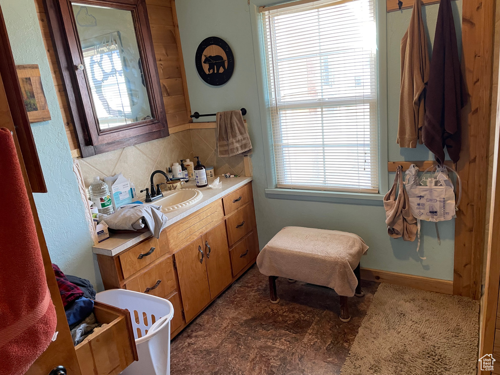 Bathroom featuring vanity and backsplash