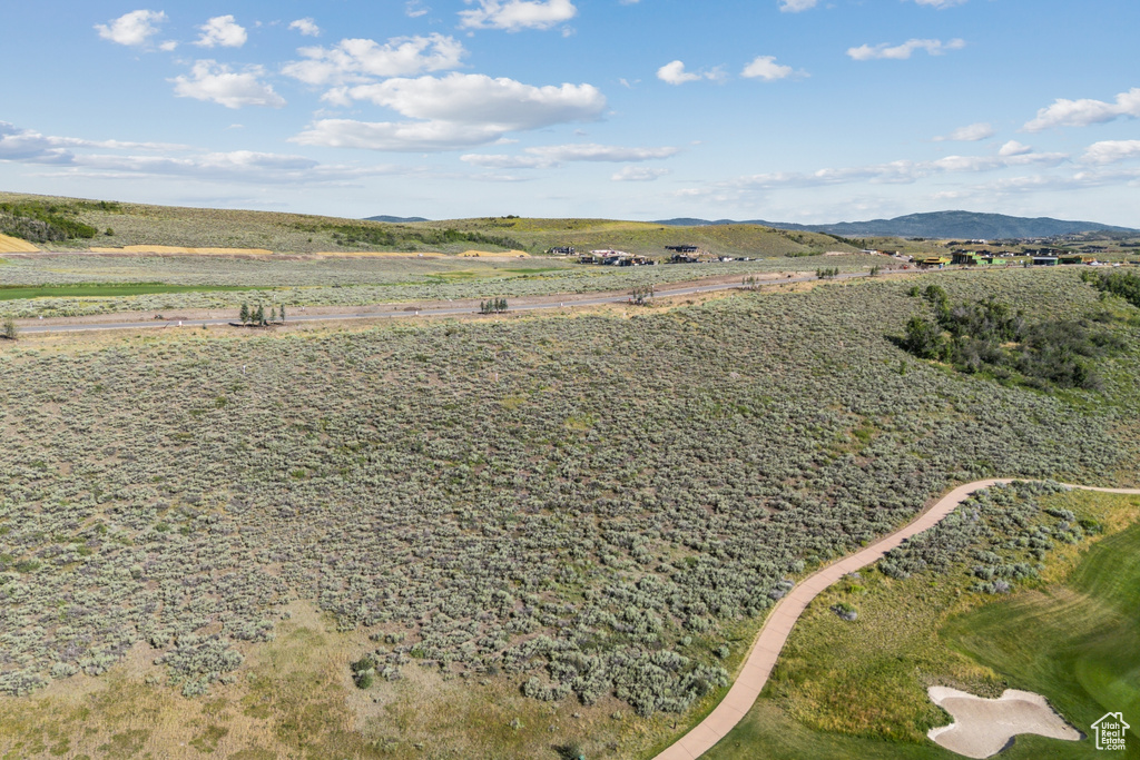 Aerial view of property and surrounding area featuring mountains