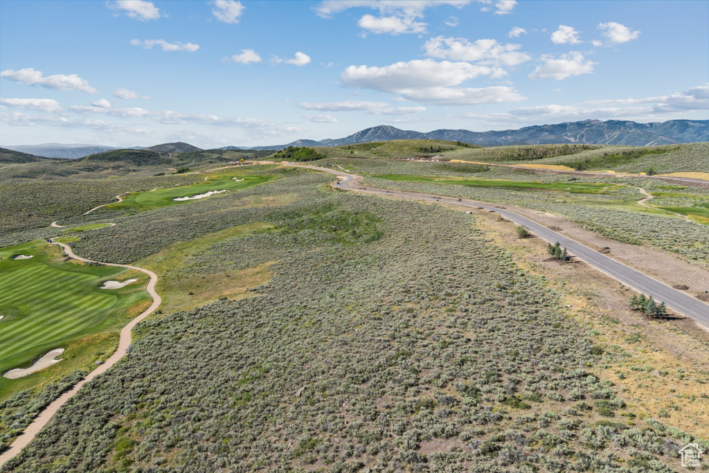 Bird's eye view of a mountain backdrop and a local golf course