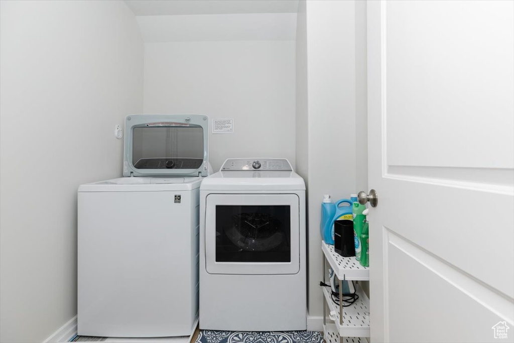 Clothes washing area featuring washing machine and clothes dryer