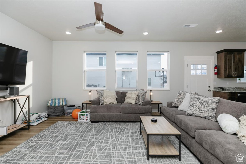 Living room featuring ceiling fan and light hardwood / wood-style floors