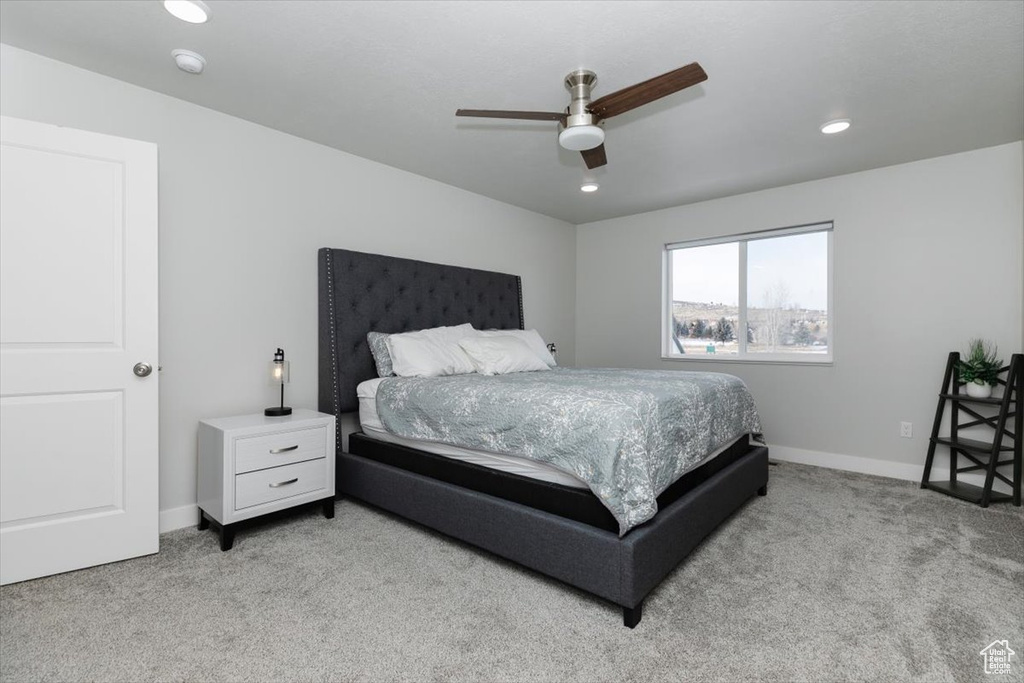 Carpeted bedroom with ceiling fan