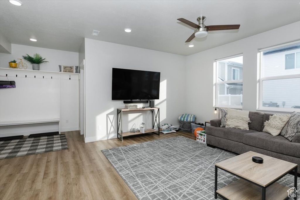 Living room featuring ceiling fan and light hardwood / wood-style floors