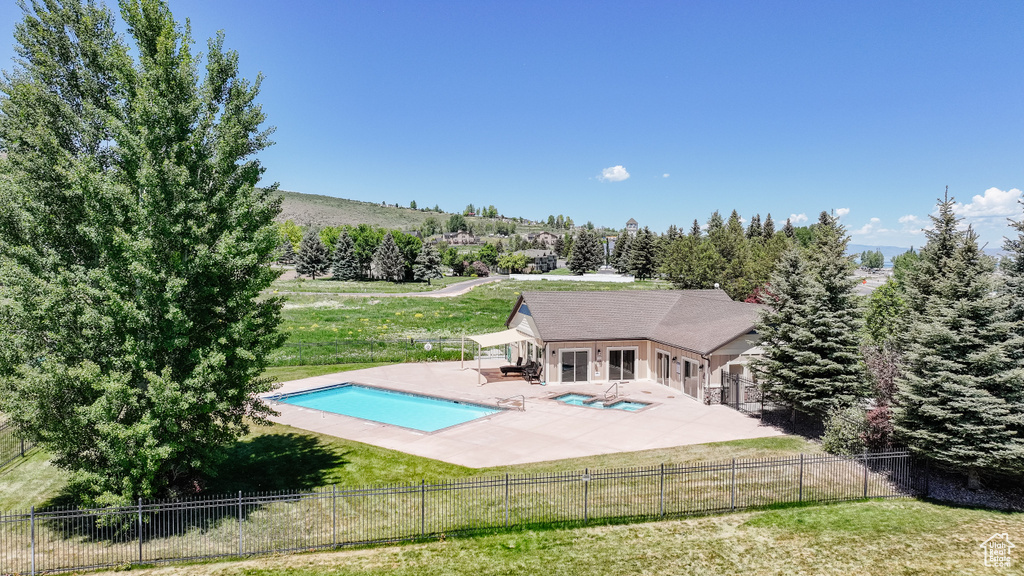 View of pool with a patio area and a fenced backyard