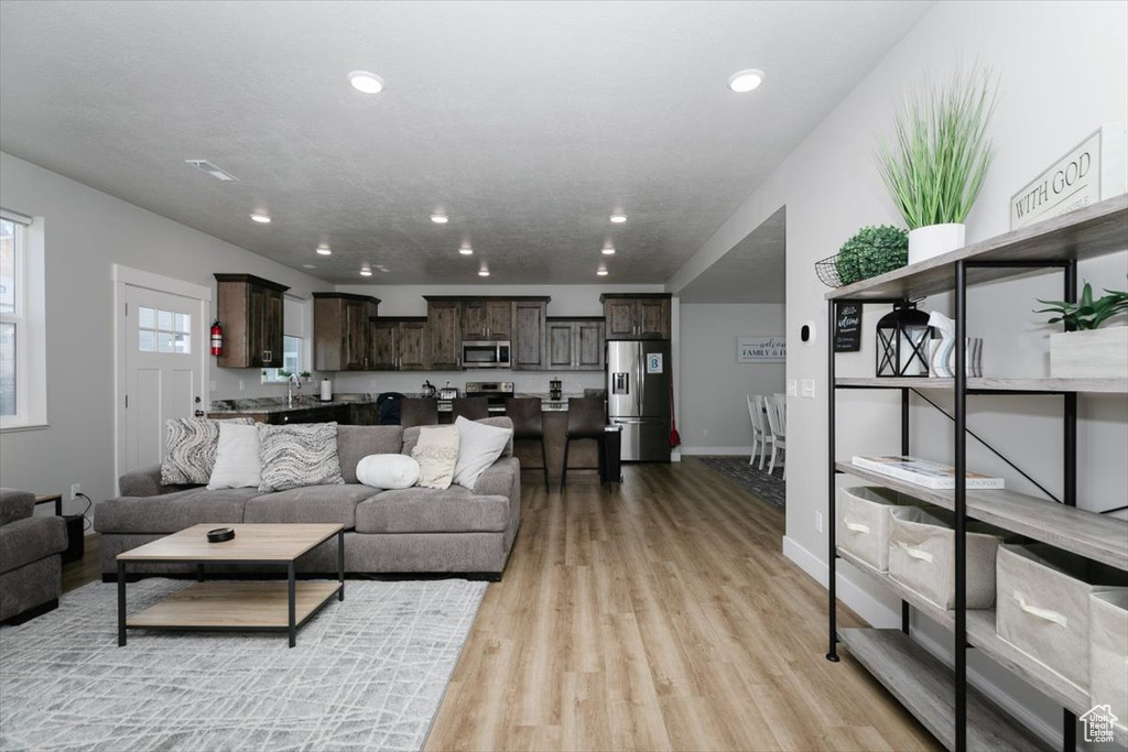 Living room with light hardwood / wood-style floors