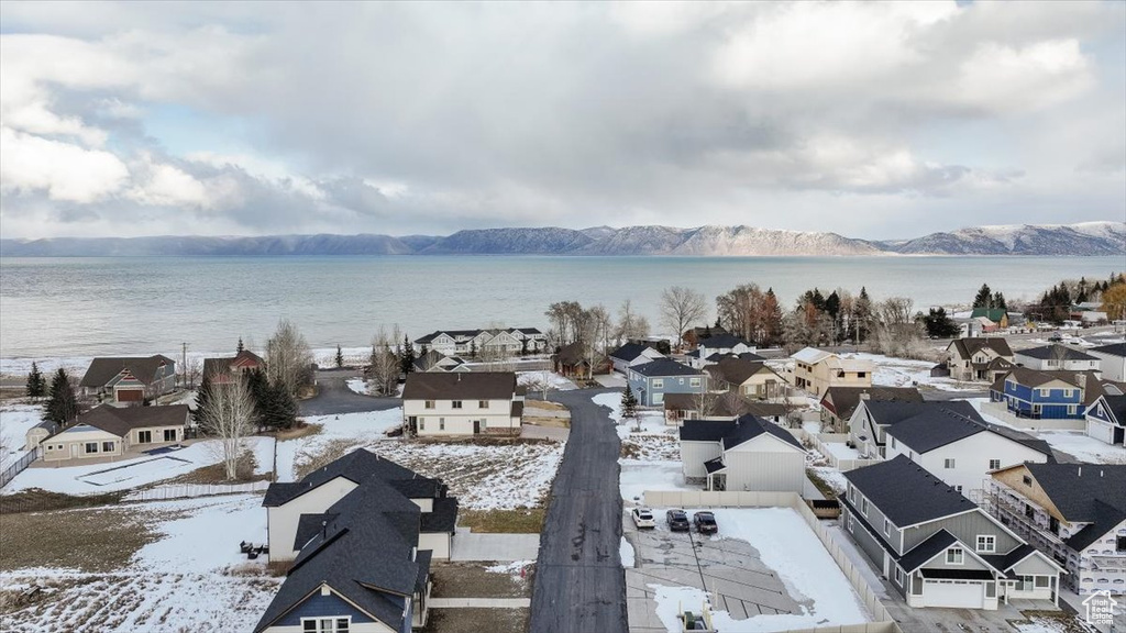 Snowy aerial view with a water and mountain view