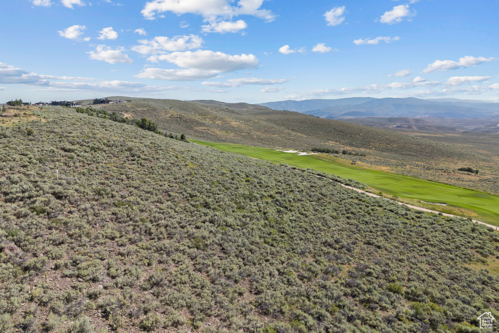 View of mountain background featuring a local golf course