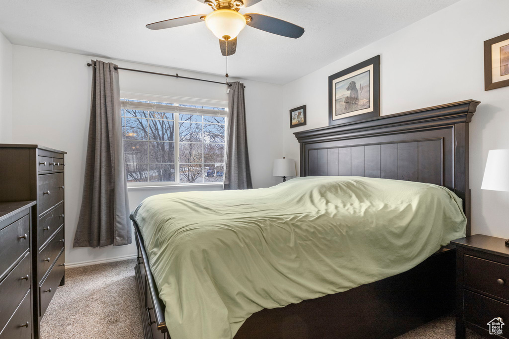 Bedroom featuring ceiling fan and carpet floors