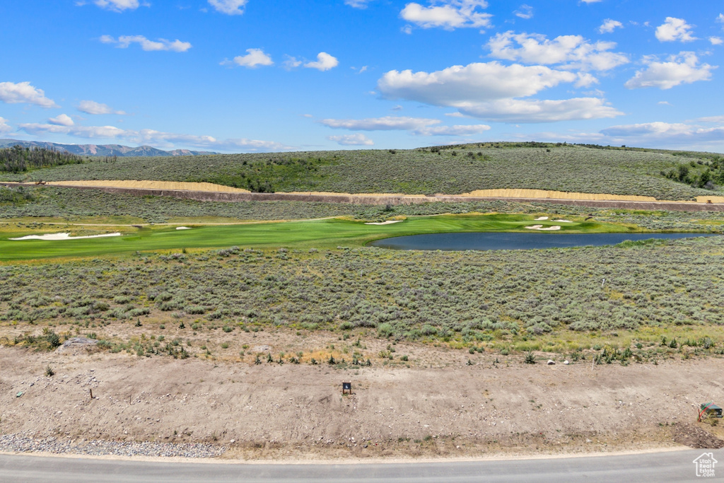 Surrounding community with a water and mountain view and view of golf course
