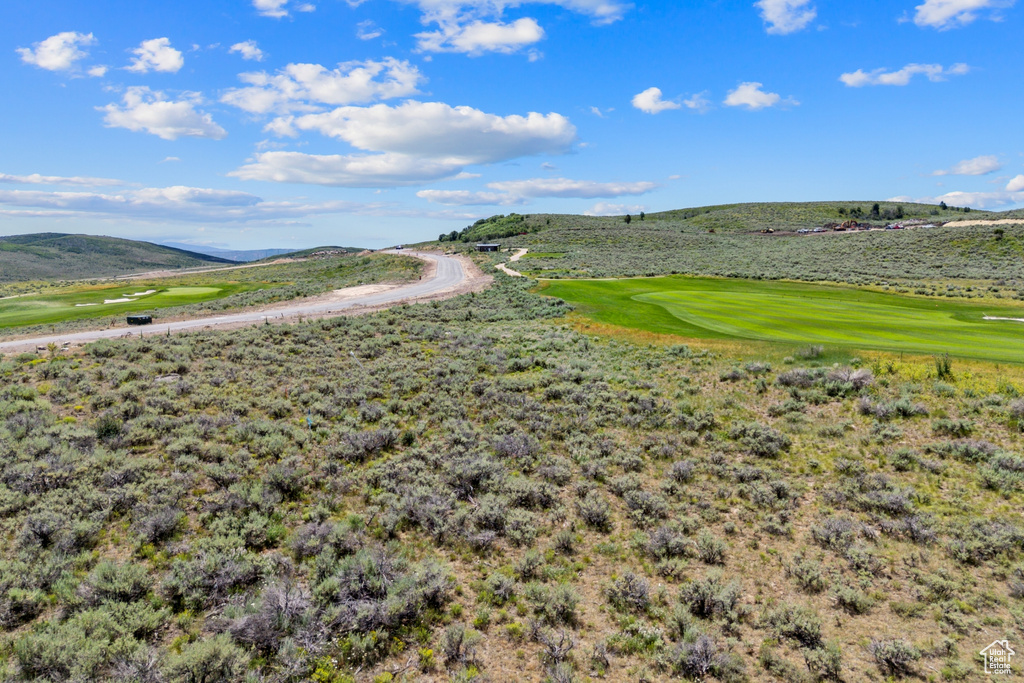 View of property's community with a mountain view and view of golf course