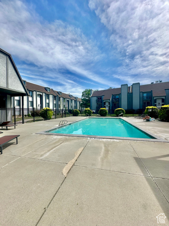 Community pool with a residential view and a patio