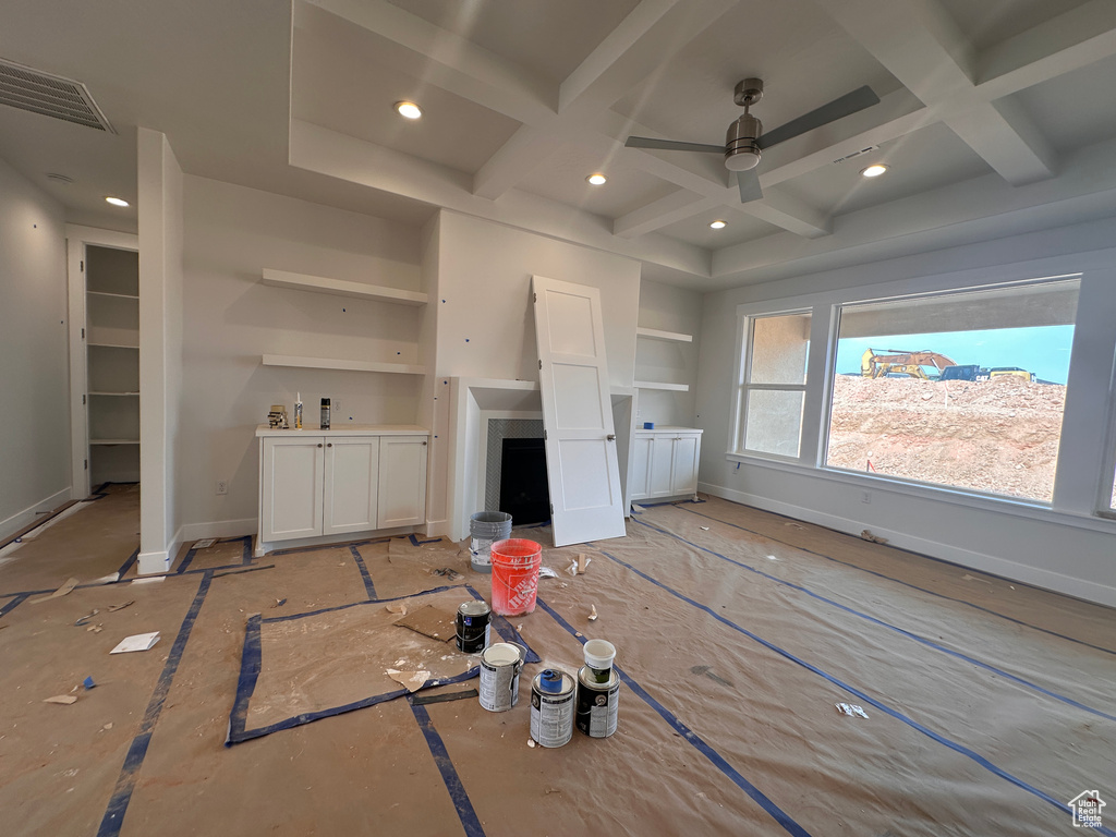 Unfurnished living room featuring coffered ceiling, a ceiling fan, recessed lighting, and beam ceiling