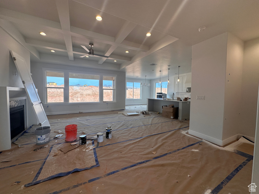 Unfurnished living room with recessed lighting, coffered ceiling, ceiling fan, beam ceiling, and a fireplace