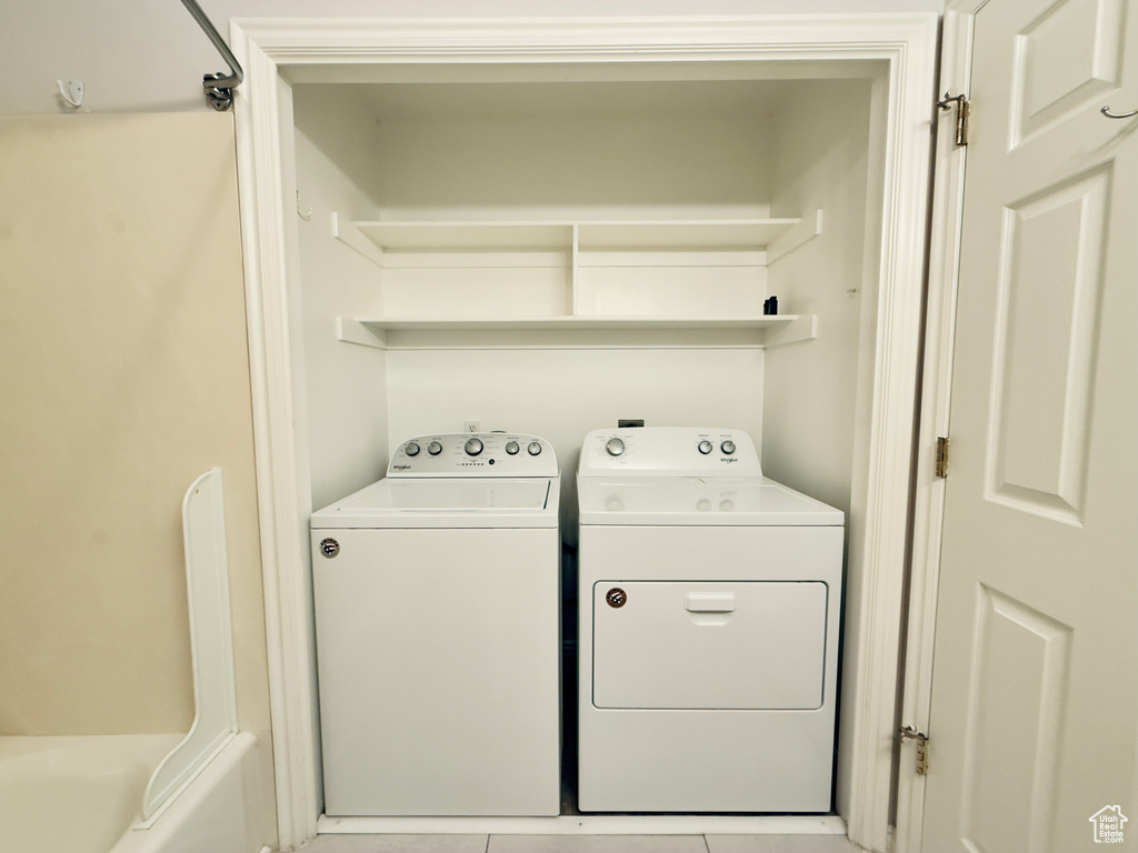Laundry room featuring washer and clothes dryer