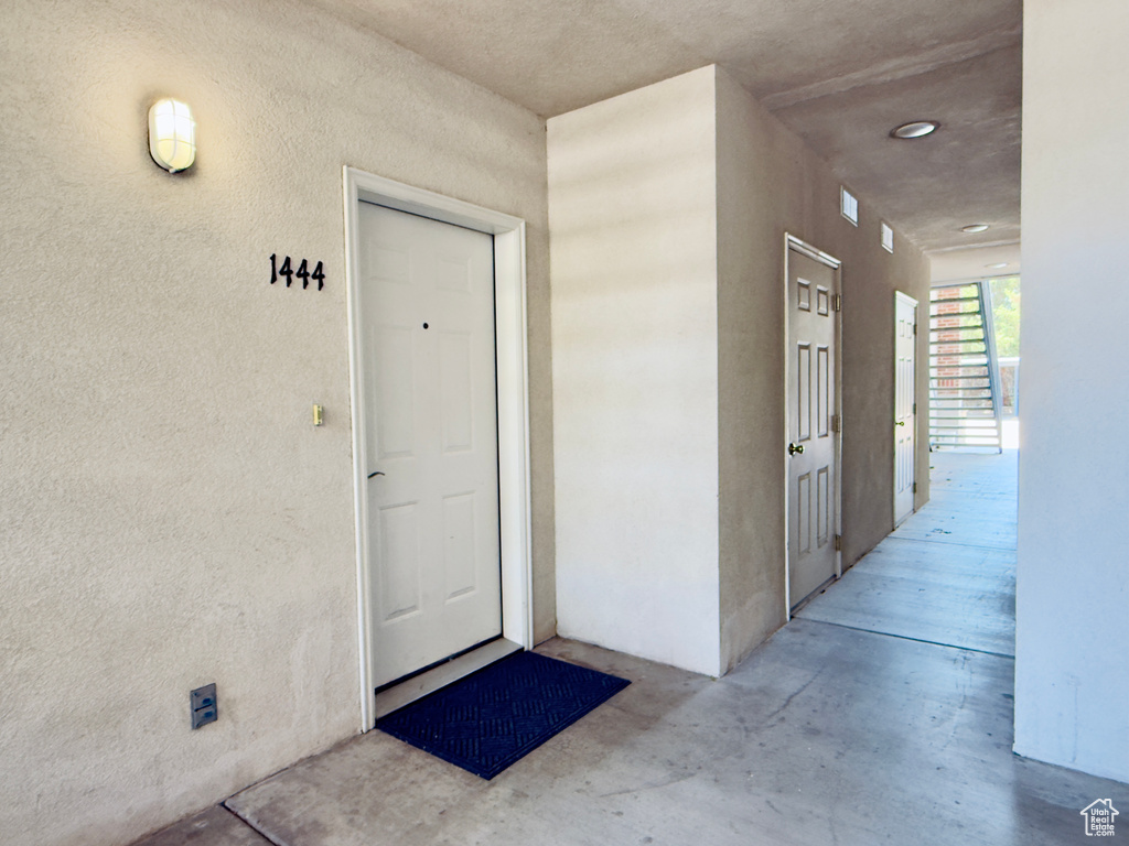 Entrance to property featuring stucco siding