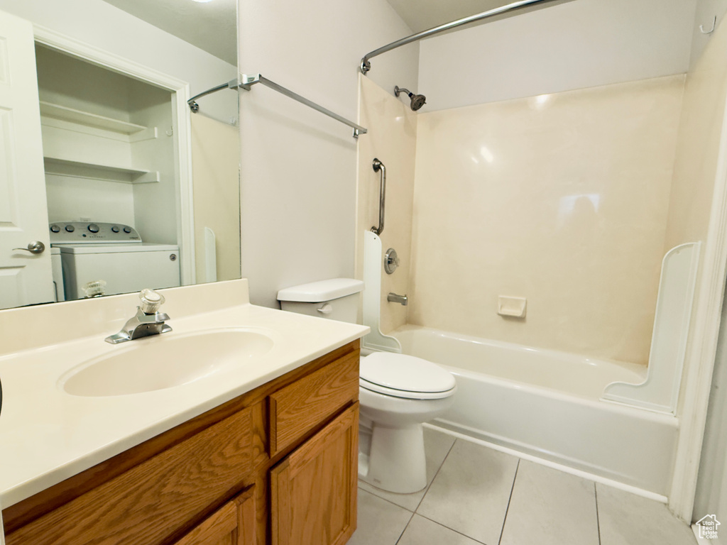 Full bathroom featuring washer / clothes dryer, tile patterned floors, shower / bathtub combination, and vanity