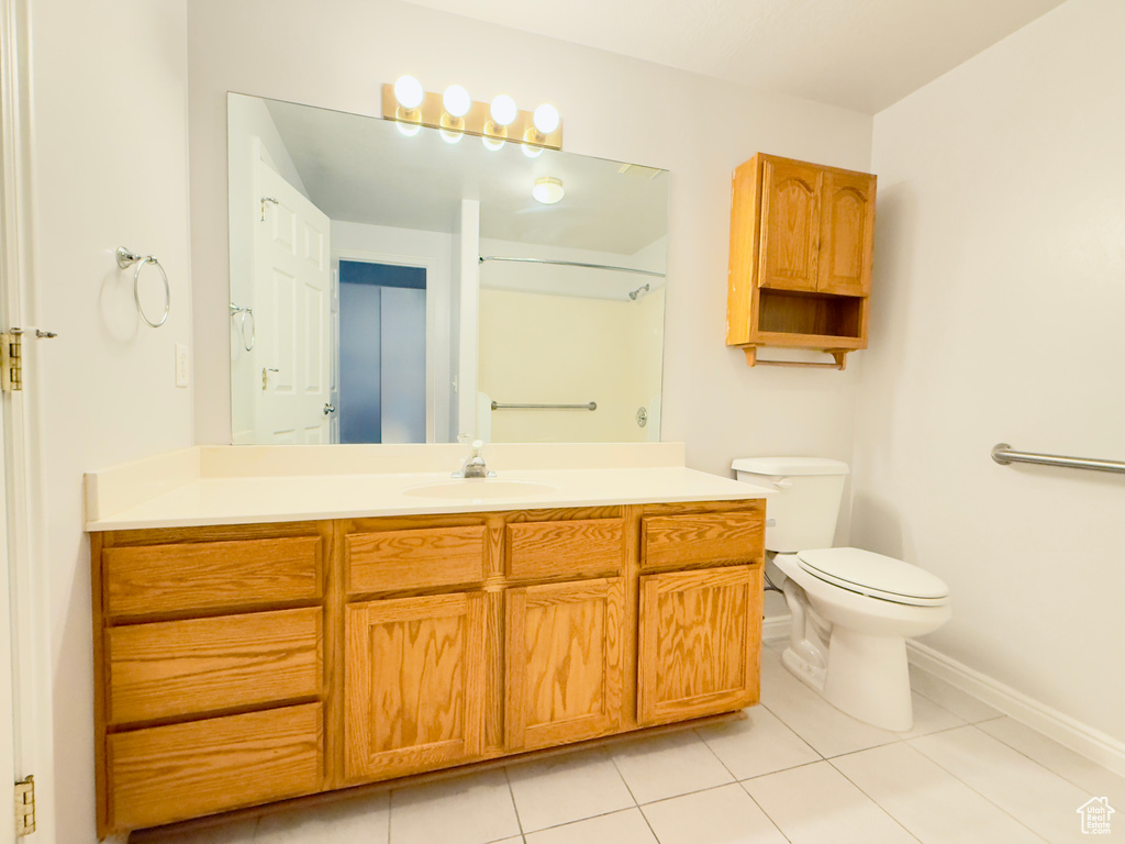 Bathroom featuring vanity, tile patterned floors, and a shower