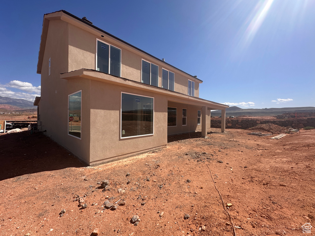 Back of property featuring stucco siding and a mountain view