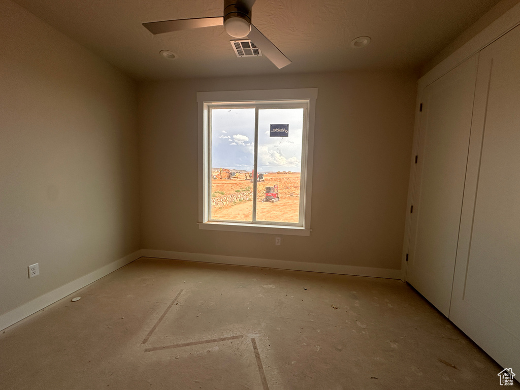 Empty room featuring baseboards and ceiling fan