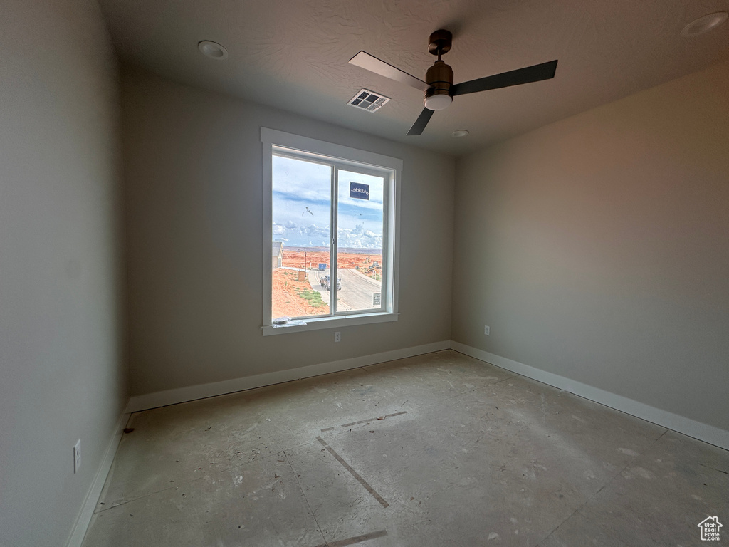 Spare room with baseboards and ceiling fan