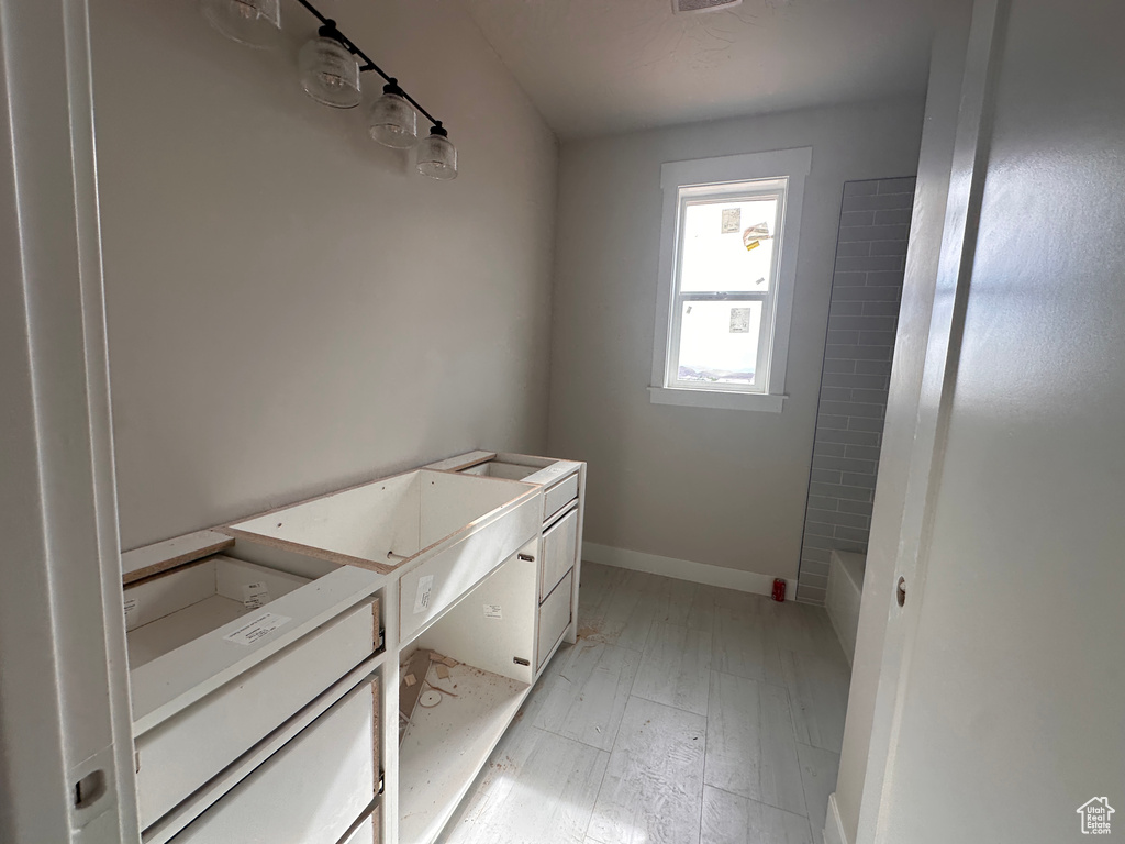 Full bath featuring vanity and baseboards