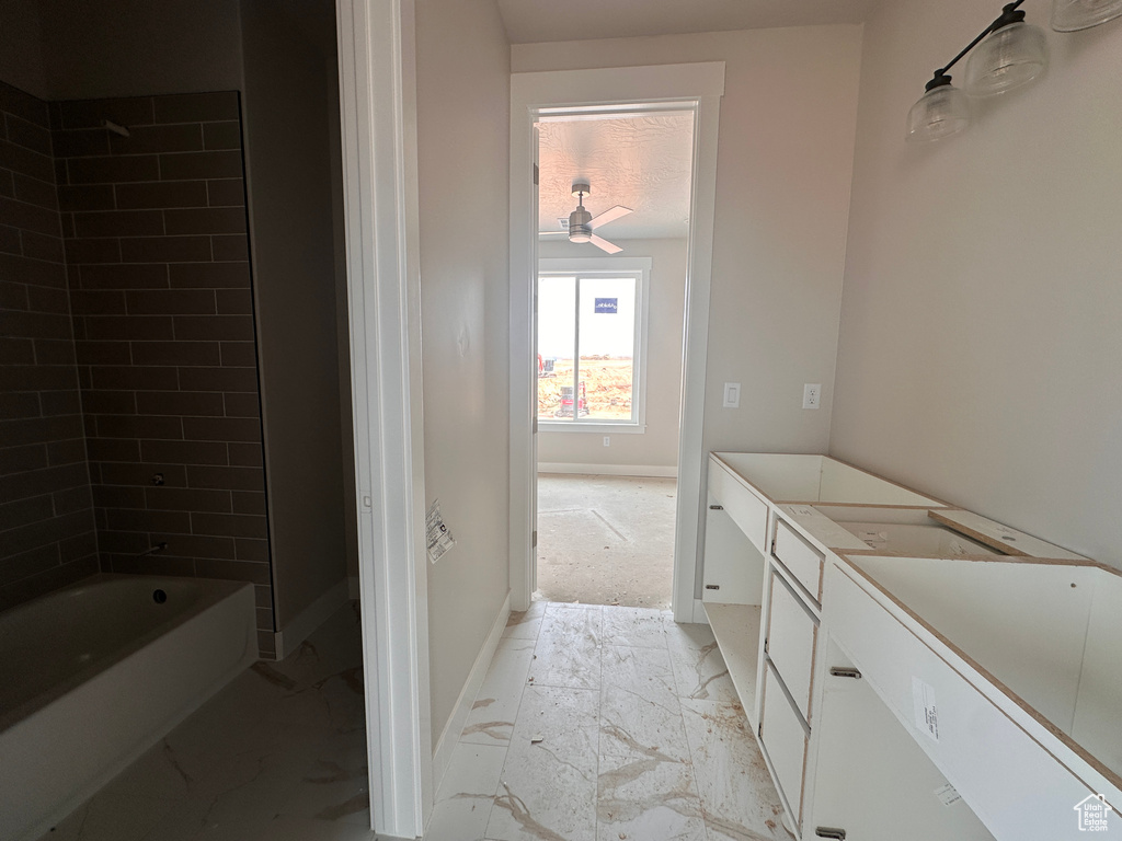 Full bath with vanity, tub / shower combination, and a ceiling fan