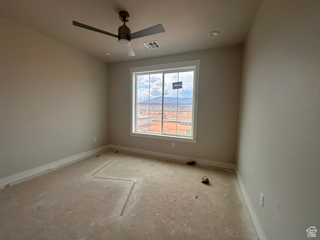 Empty room with baseboards and a ceiling fan