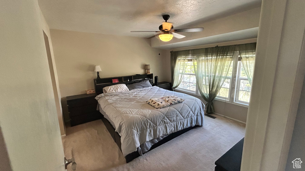 Bedroom with baseboards, carpet, and ceiling fan