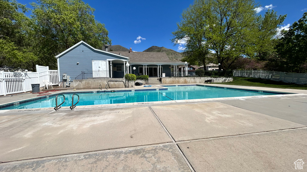 View of swimming pool featuring a patio, fence, and a fenced in pool