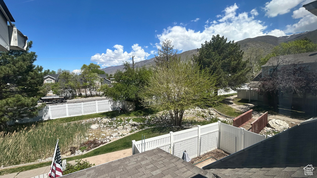 View of yard with fence and a mountain view