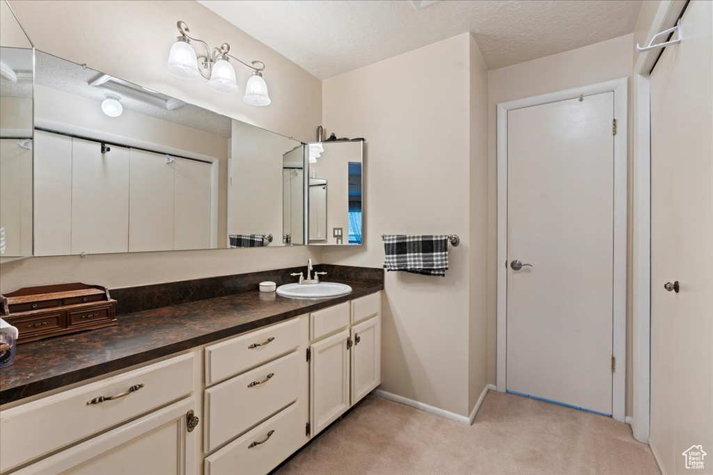 Bathroom featuring vanity and a textured ceiling