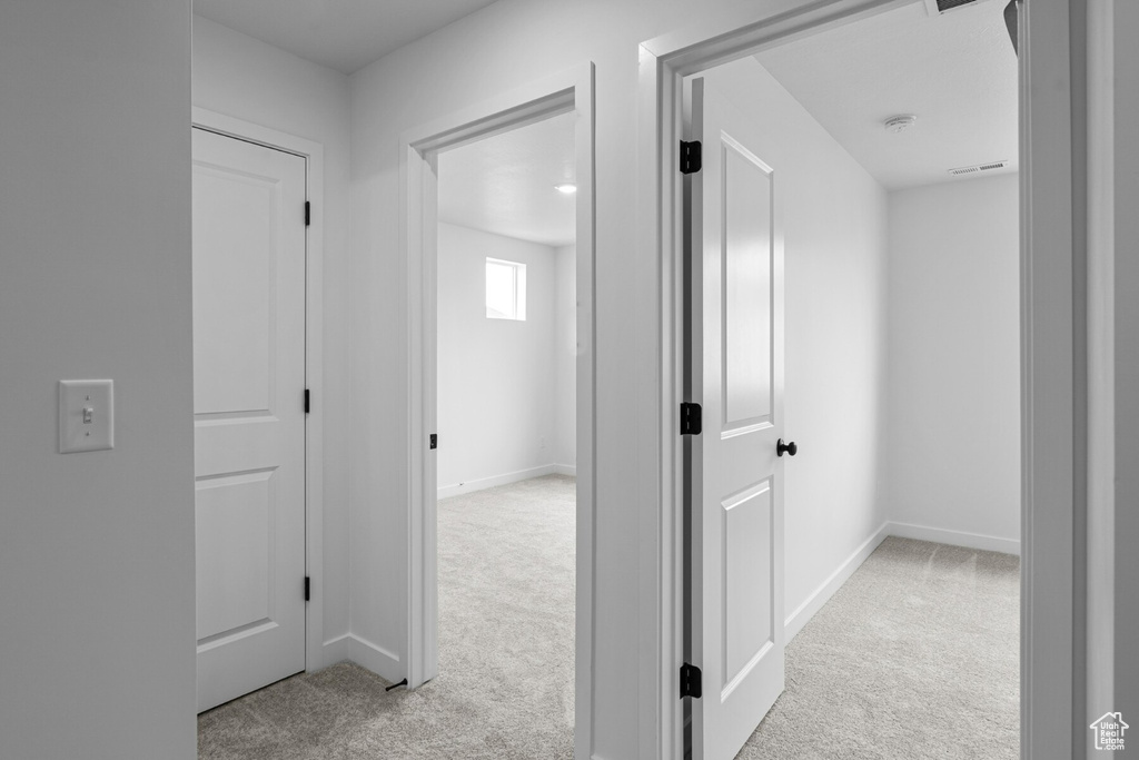 Corridor with light colored carpet