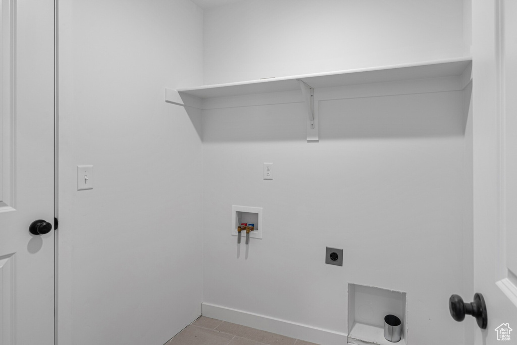 Clothes washing area featuring washer hookup, hookup for an electric dryer, and light tile patterned floors