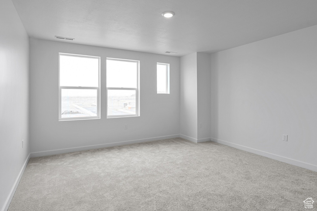 Spare room featuring light carpet