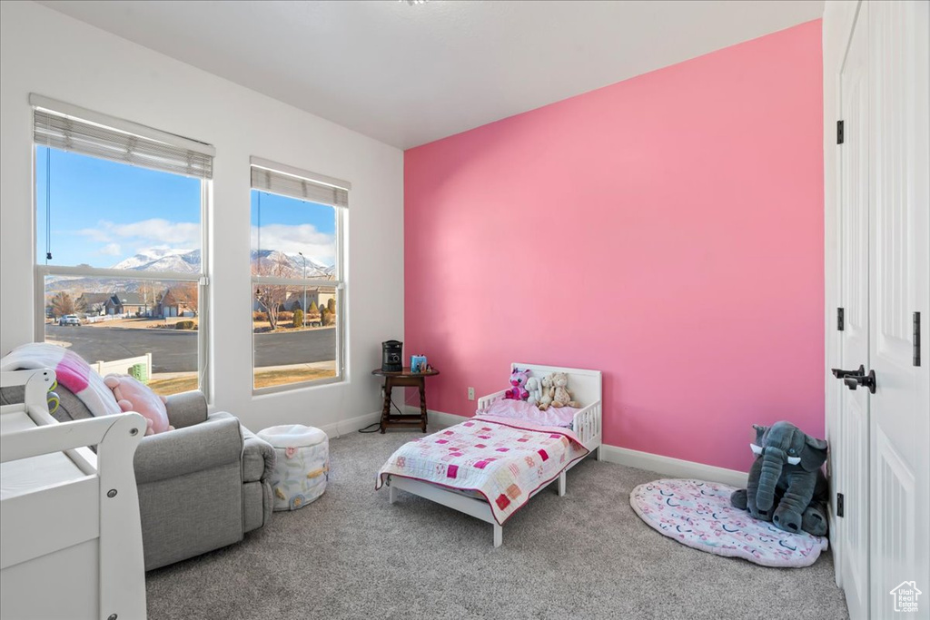 Carpeted bedroom with a mountain view