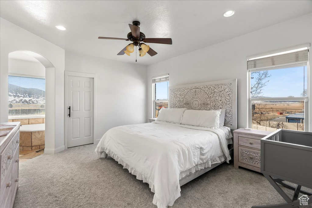 Carpeted bedroom featuring ceiling fan