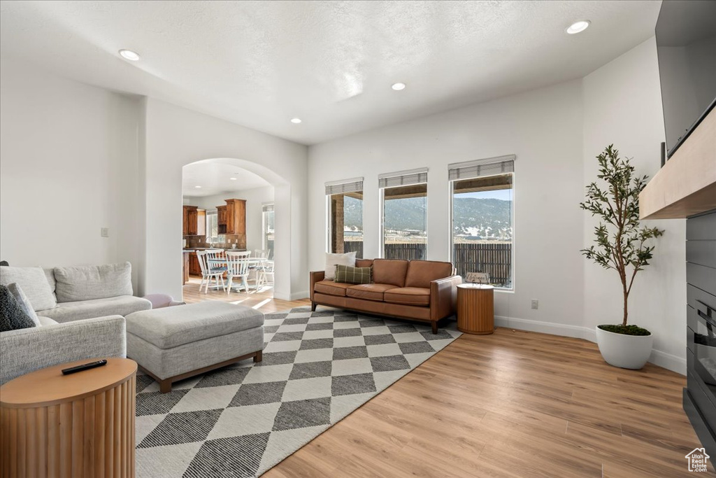 Living room with light hardwood / wood-style flooring and a textured ceiling