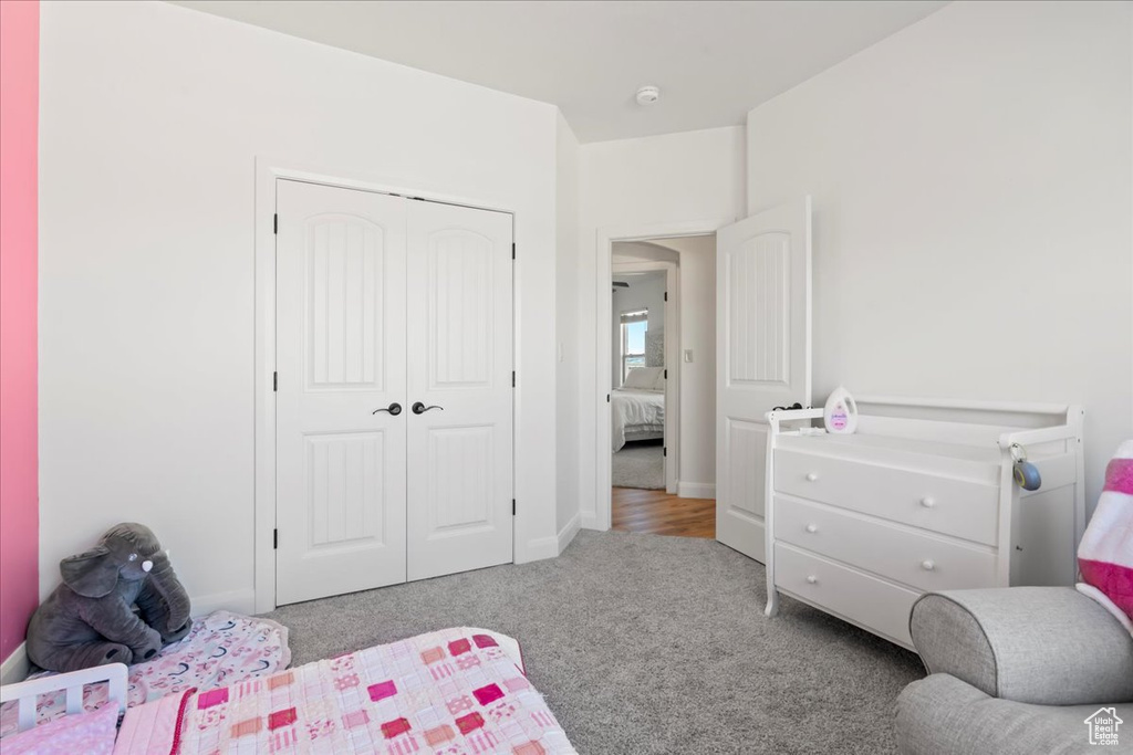 Carpeted bedroom featuring a closet