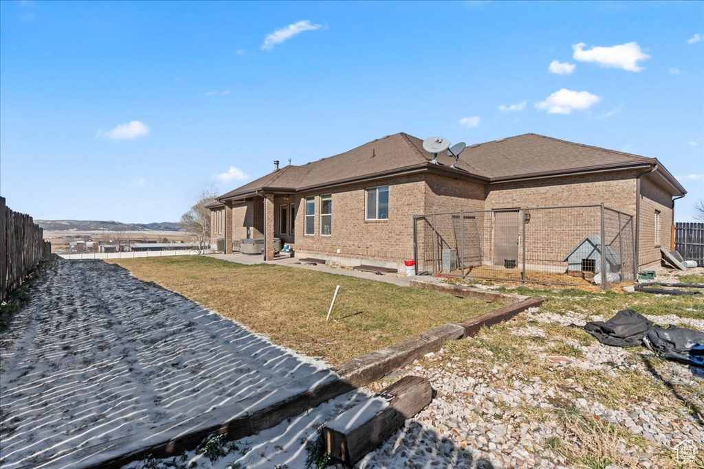 Back of house with a lawn