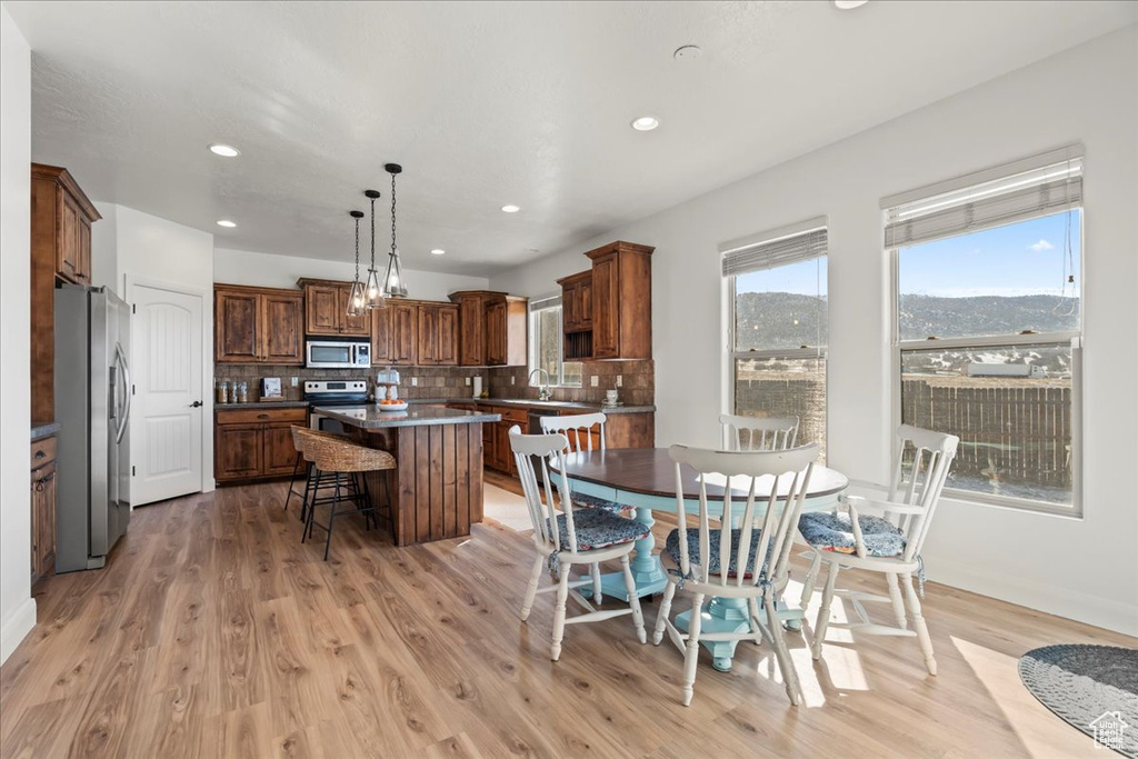 Dining area with a mountain view and light hardwood / wood-style floors