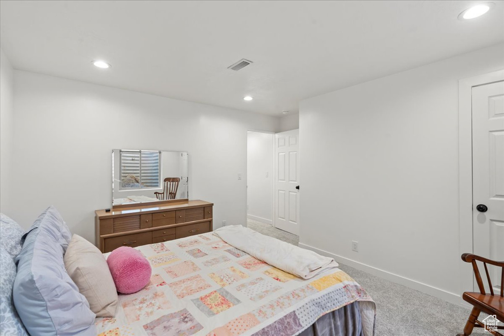 Bedroom with light colored carpet