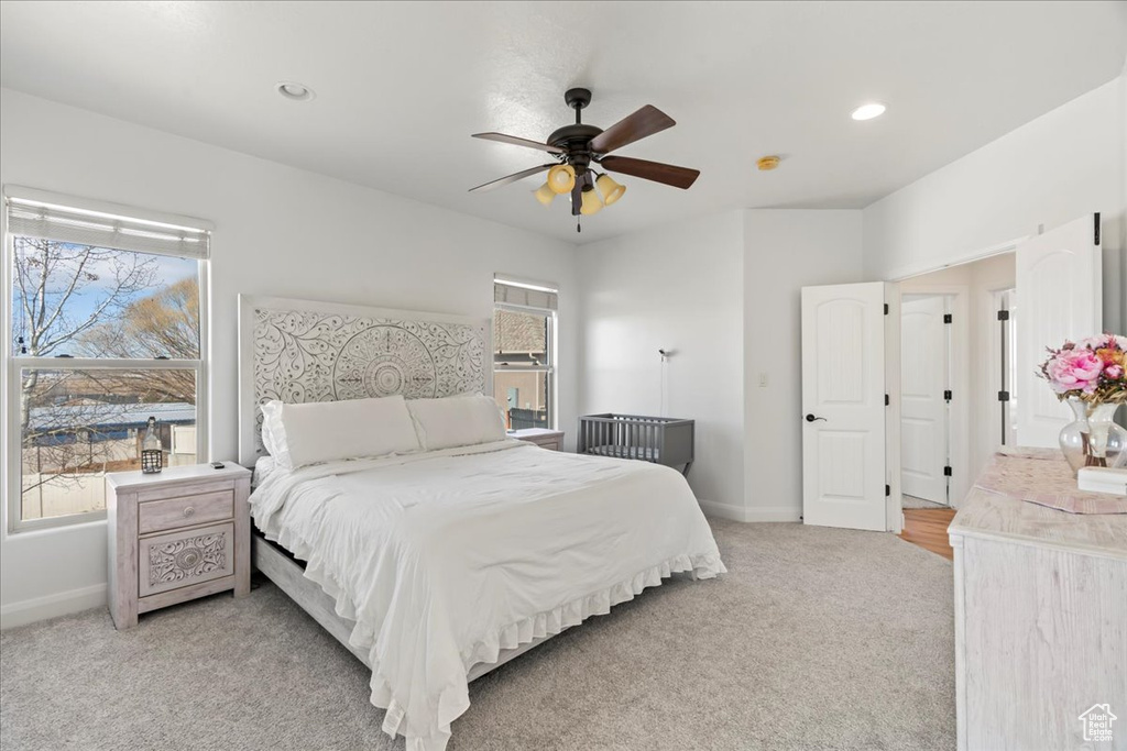 Bedroom featuring light carpet and ceiling fan