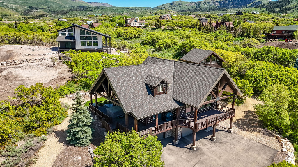 Aerial view of property and surrounding area with a mountainous background