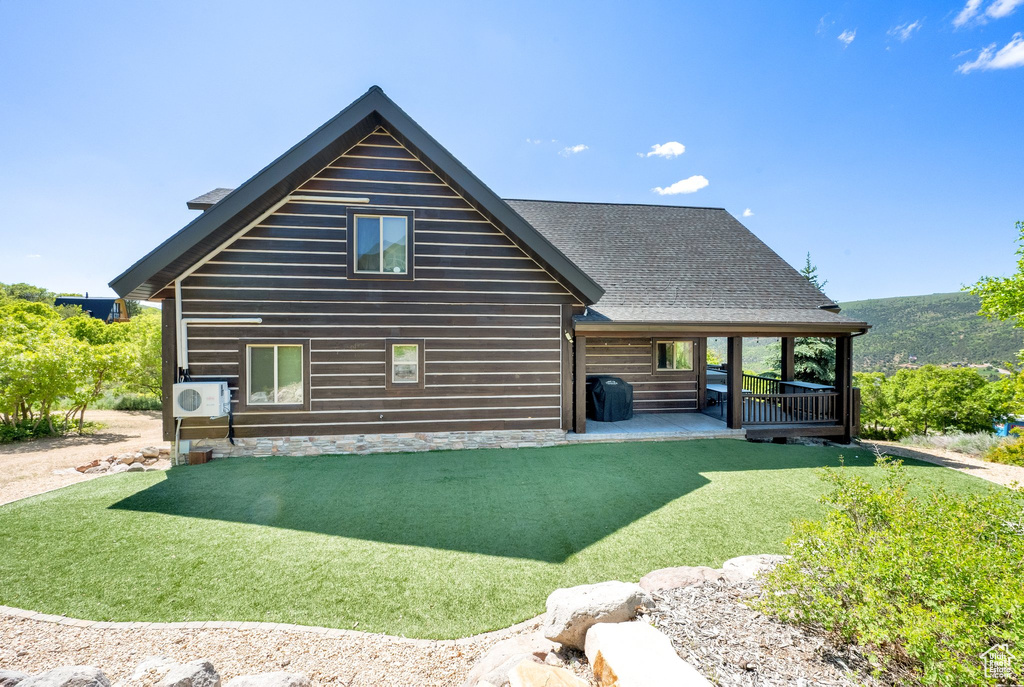 Rear view of house with a lawn