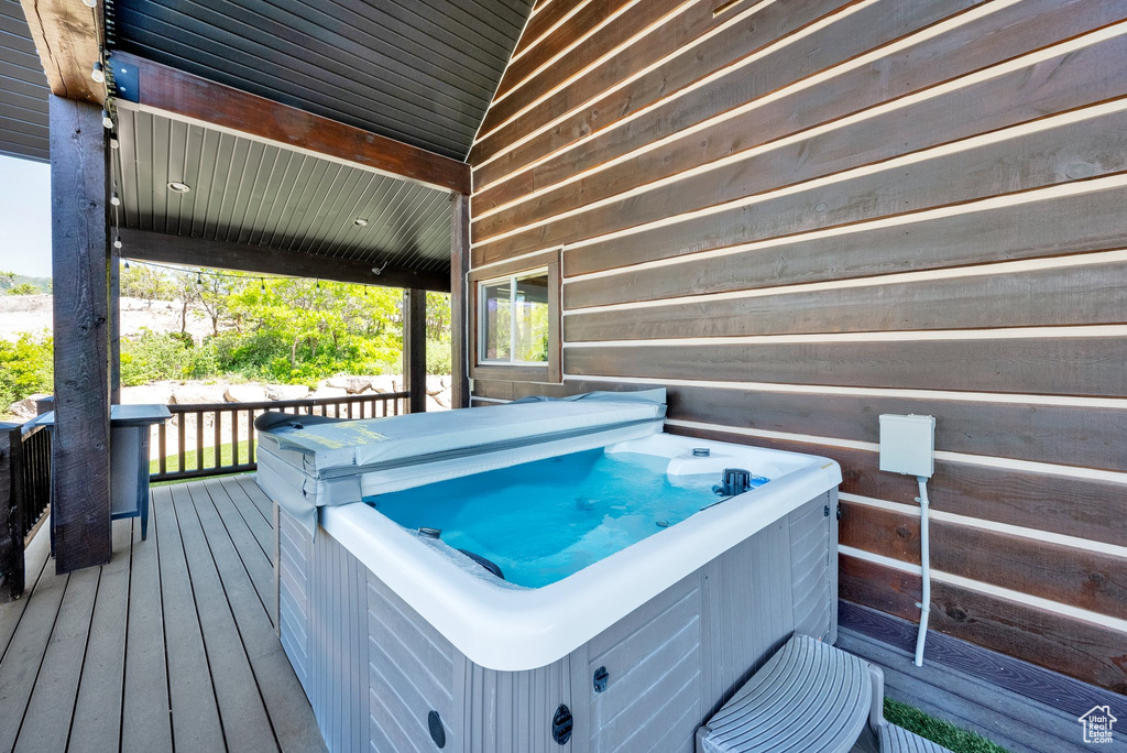 Wooden deck featuring a hot tub