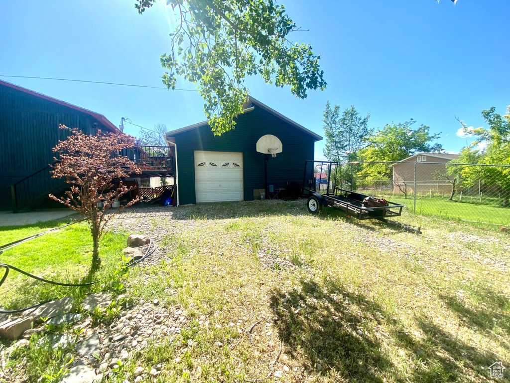 Exterior space with an outbuilding and a garage