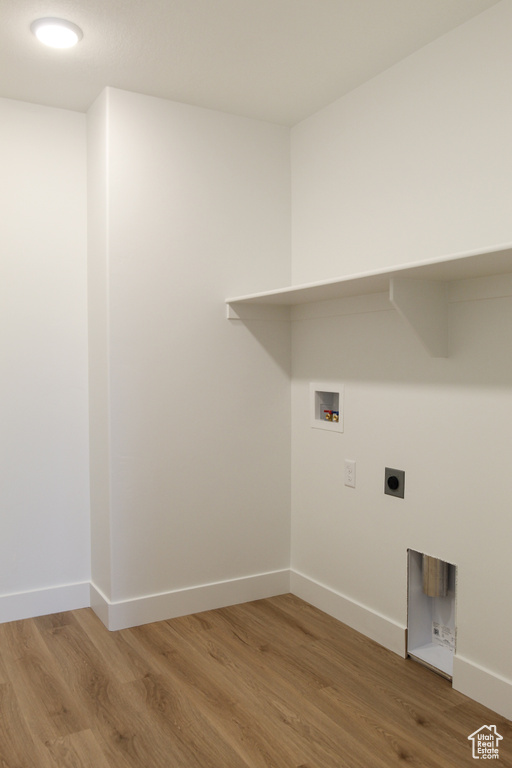 Washroom with washer hookup, light wood-type flooring, hookup for an electric dryer, and baseboards